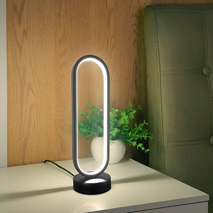 Lampe de table LED noire sur une table en bois avec plante décorative